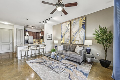 a living room with a couch and a ceiling fan